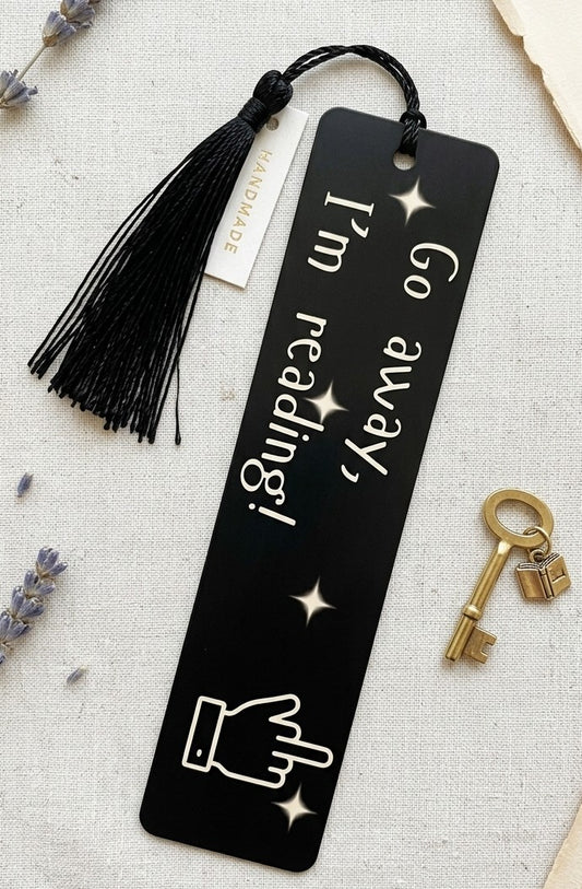 Go Away I'm Reading black PET plastic bookmark with bold white lettering and celestial star accents
