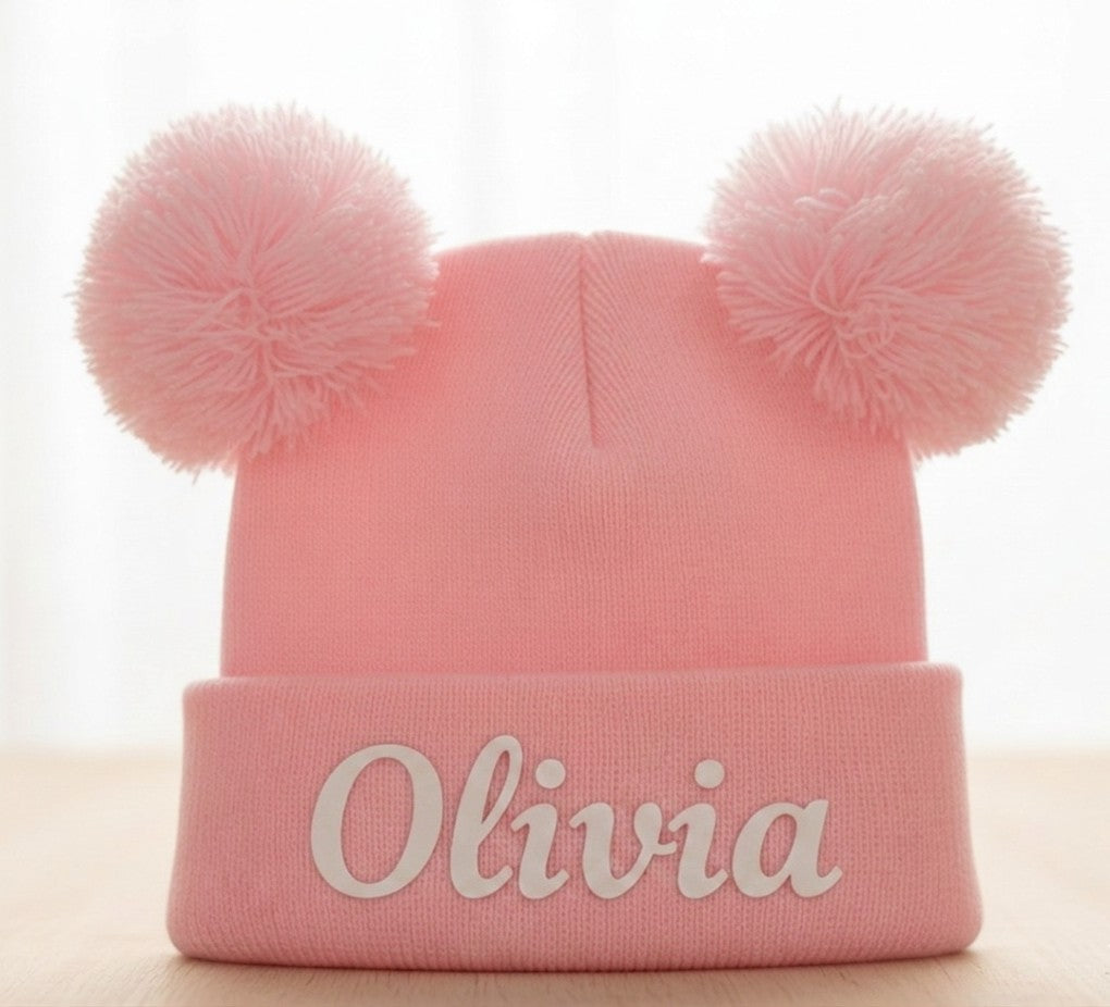 Pink personalised double pom pom baby beanie with name Olivia front view